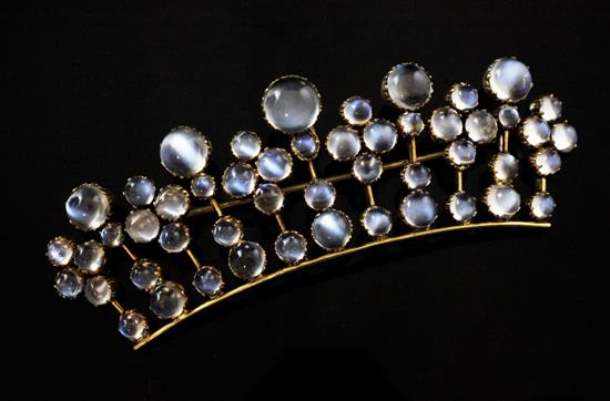 A gold and cabochon moonstone brooch of concave coronet design, 3.25in.